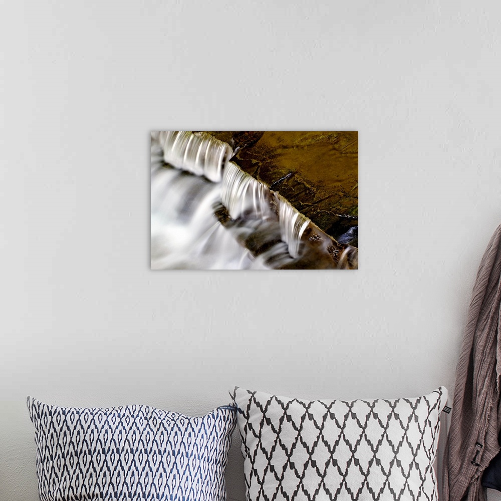 A bohemian room featuring Large photo print of water rushing downward off of rock formations.