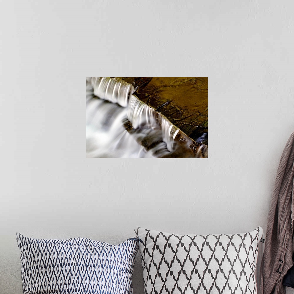A bohemian room featuring Large photo print of water rushing downward off of rock formations.