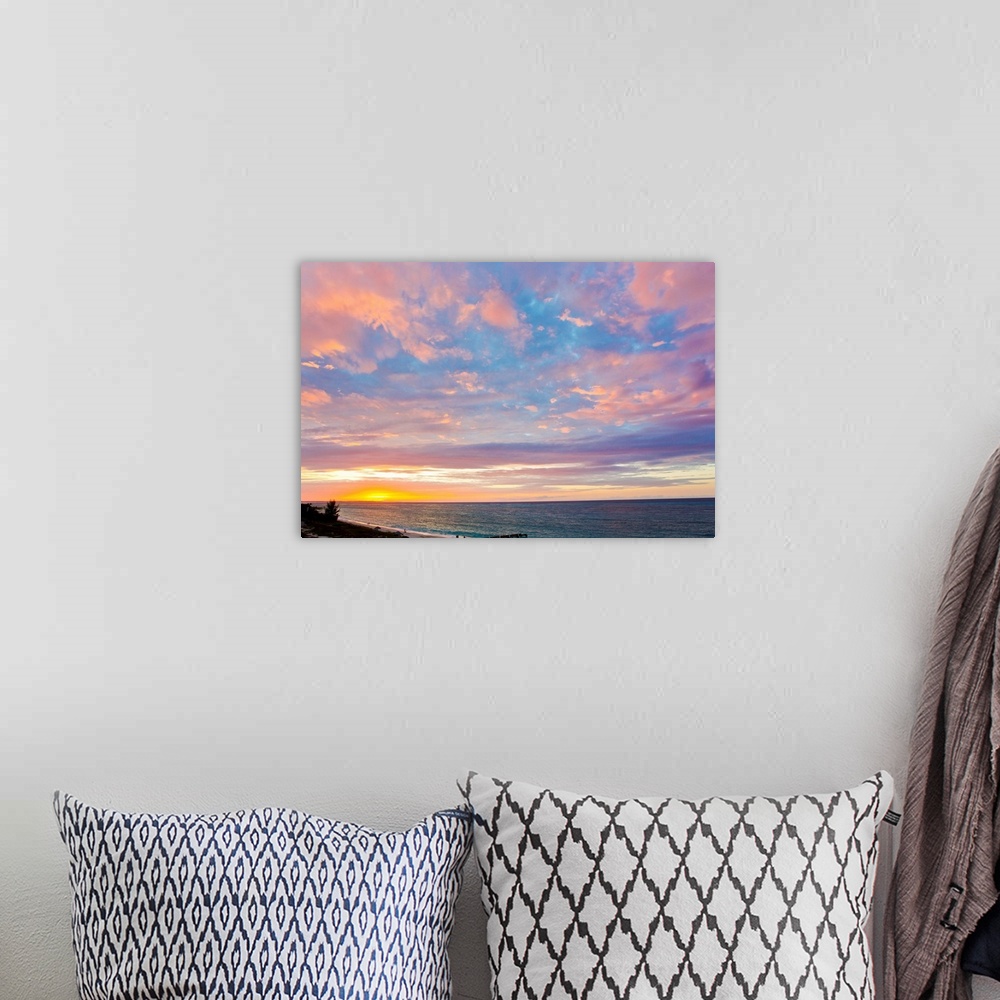 A bohemian room featuring A beautiful delicate pink and purple sky at sunset over Grace Bay, and the shore.