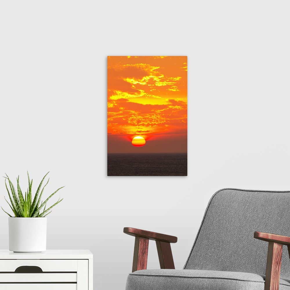 A modern room featuring A blazing sunset over the Caribbean Sea.