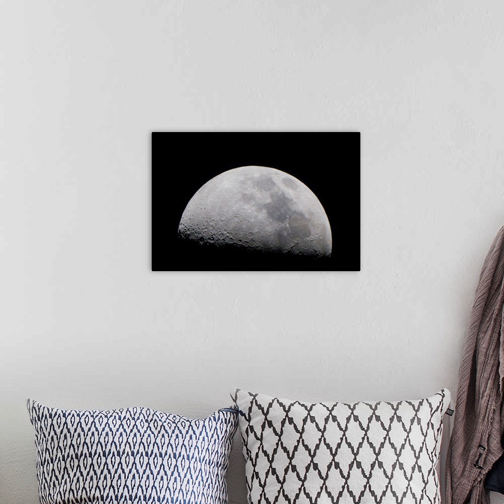 A bohemian room featuring A close up of Earth's moon and it's numerous impact craters and pits.