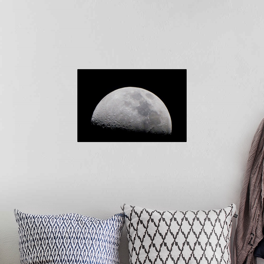A bohemian room featuring A close up of Earth's moon and it's numerous impact craters and pits.