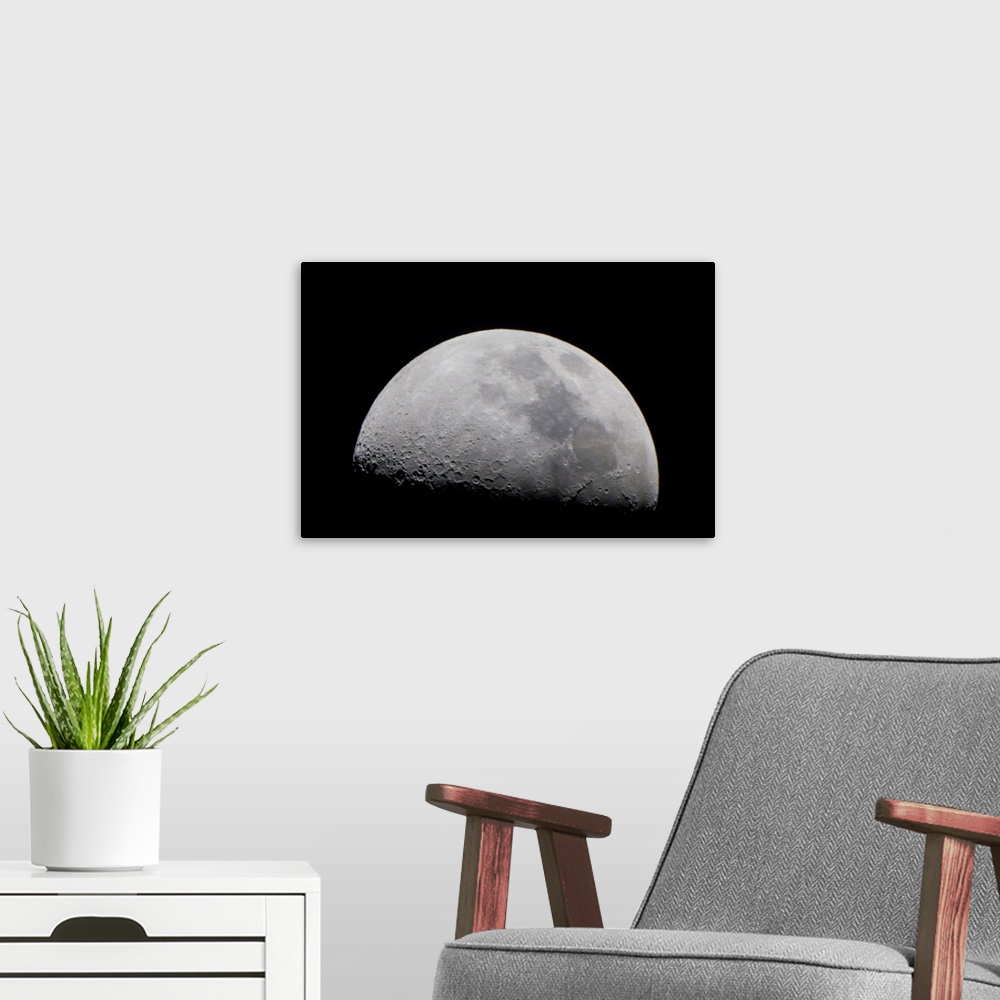 A modern room featuring A close up of Earth's moon and it's numerous impact craters and pits.