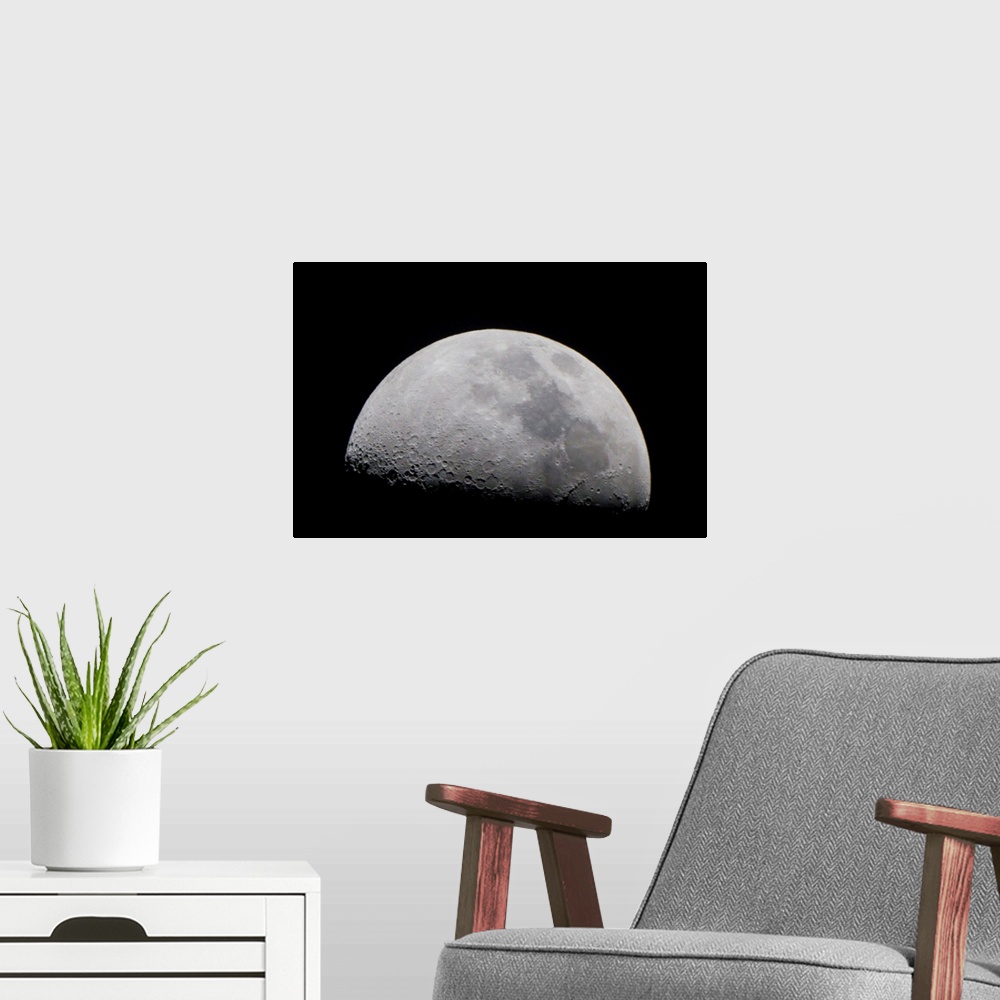 A modern room featuring A close up of Earth's moon and it's numerous impact craters and pits.