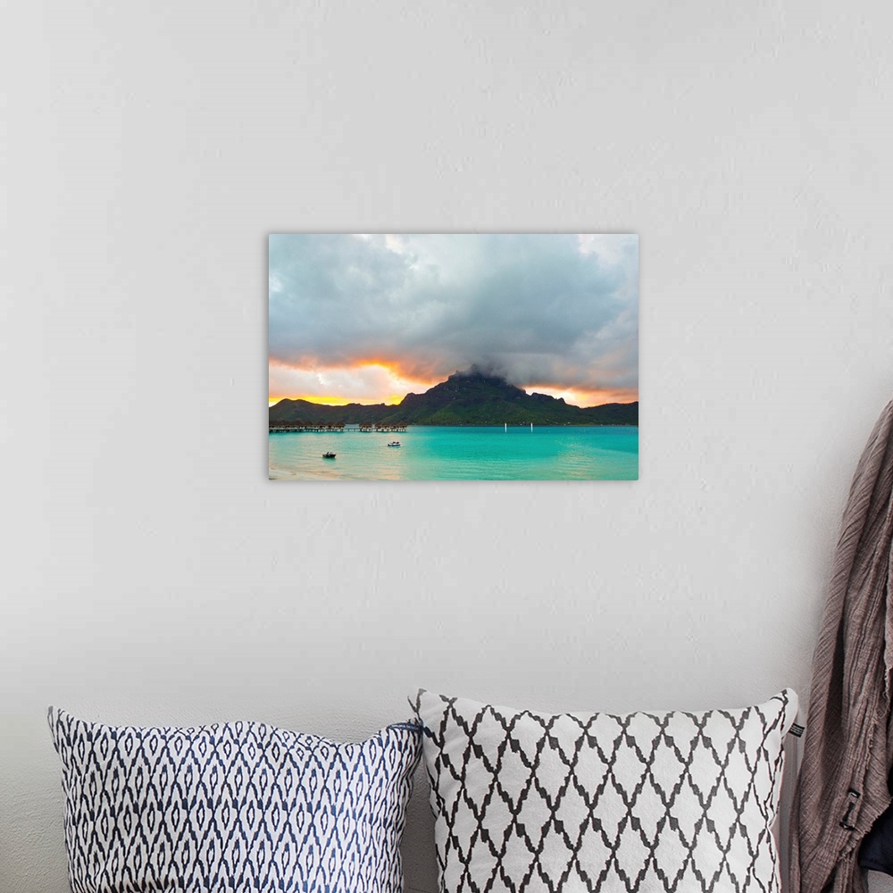 A bohemian room featuring A cloudy sunset over Mount Otemanu and the Pacific Ocean.