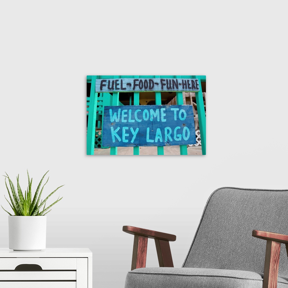 A modern room featuring A colorful sign welcoming people to Key Largo.