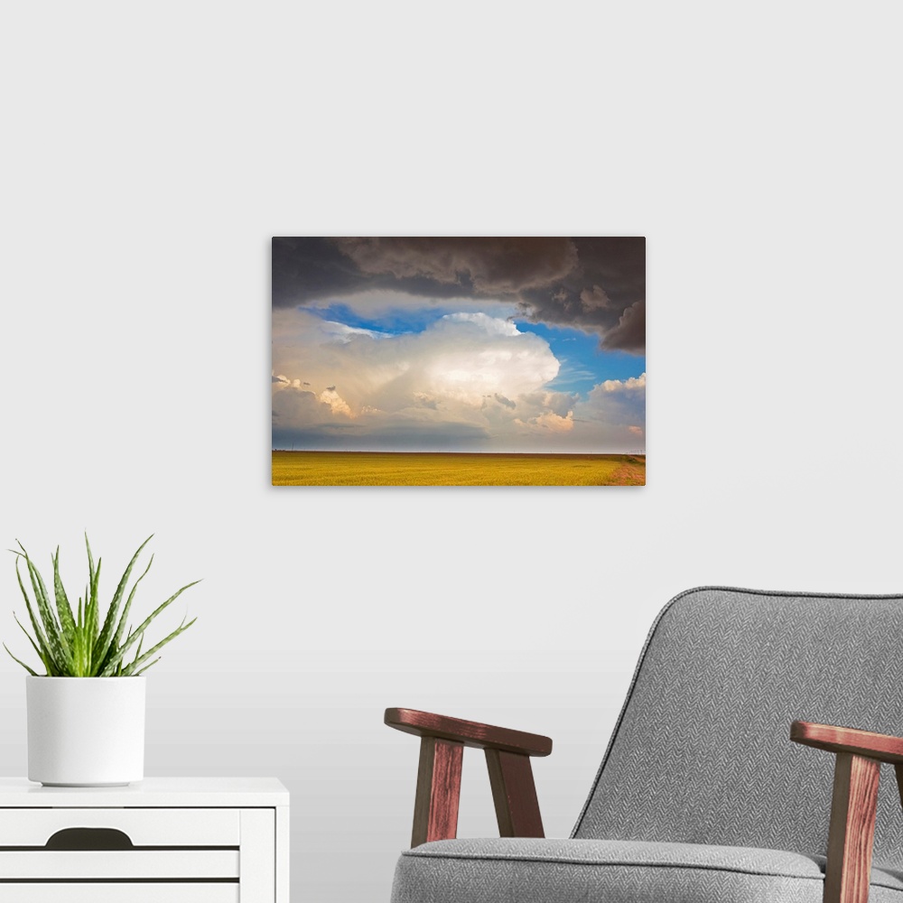 A modern room featuring A contrast of dark storms overhead and sunlit storms on the horizon.