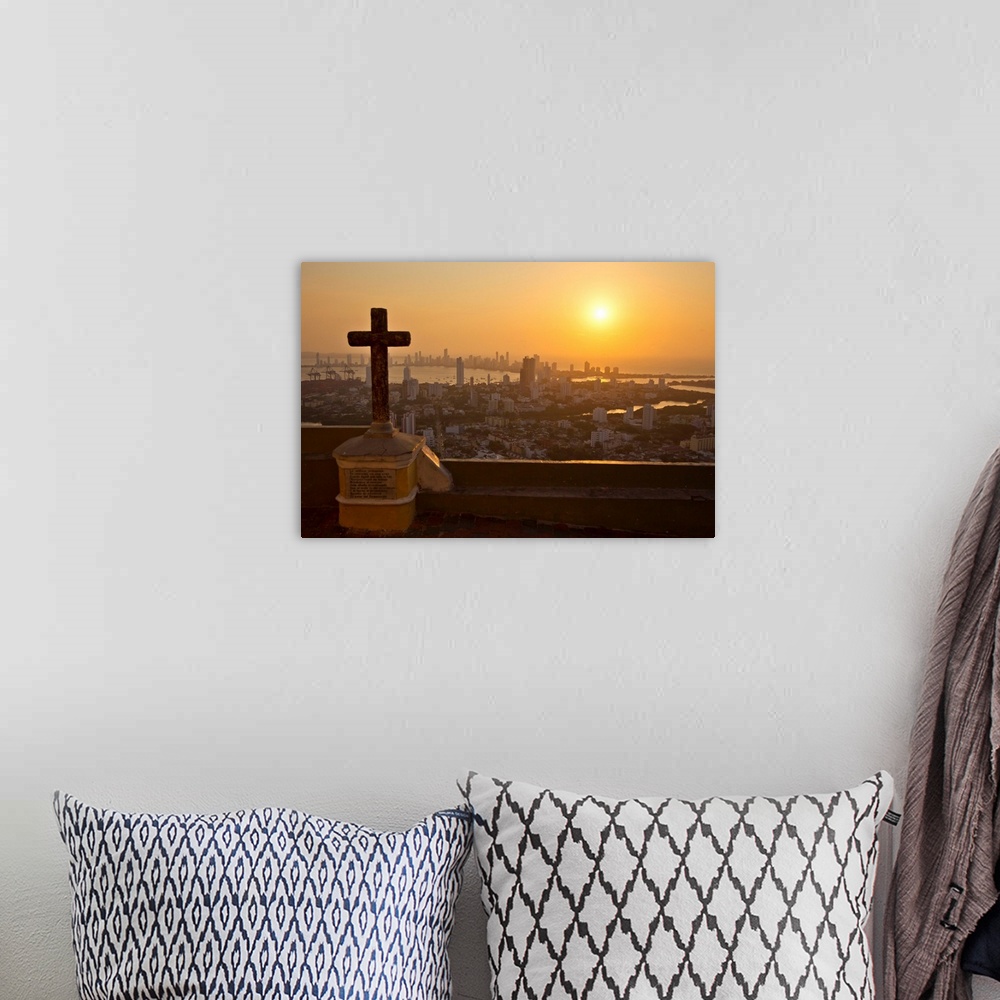 A bohemian room featuring A cross with the Cartagena skyline in the distance at sunset.
