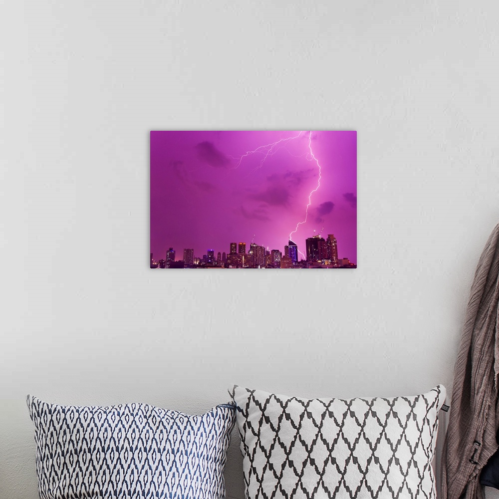 A bohemian room featuring A intense thunderstorm with lightning over the skyline of Manila.