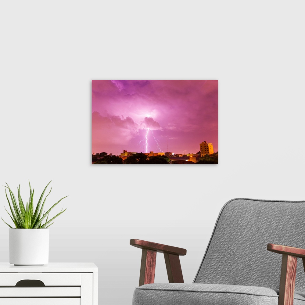 A modern room featuring A powerful lightning storm with frequent lightning bolts striking downtown Asuncion, Paraguay.