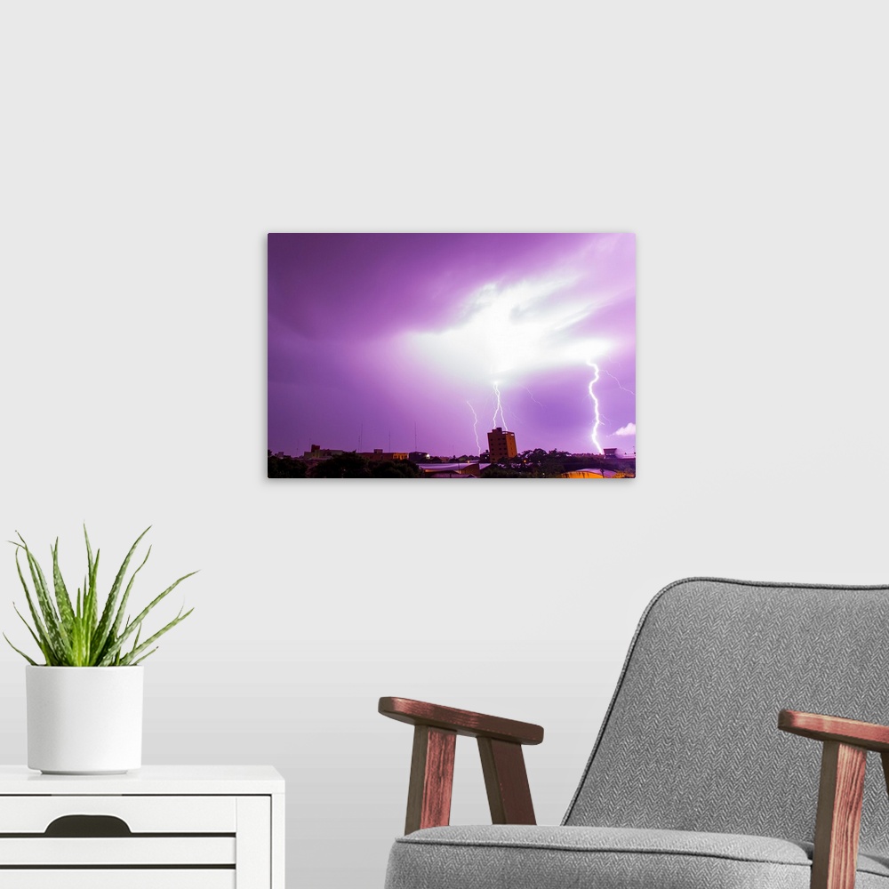 A modern room featuring A powerful lightning storm with frequent lightning bolts striking downtown Asuncion, Paraguay.
