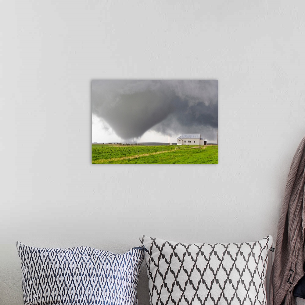 A bohemian room featuring A powerful tornado approaches a church and just misses hitting it.