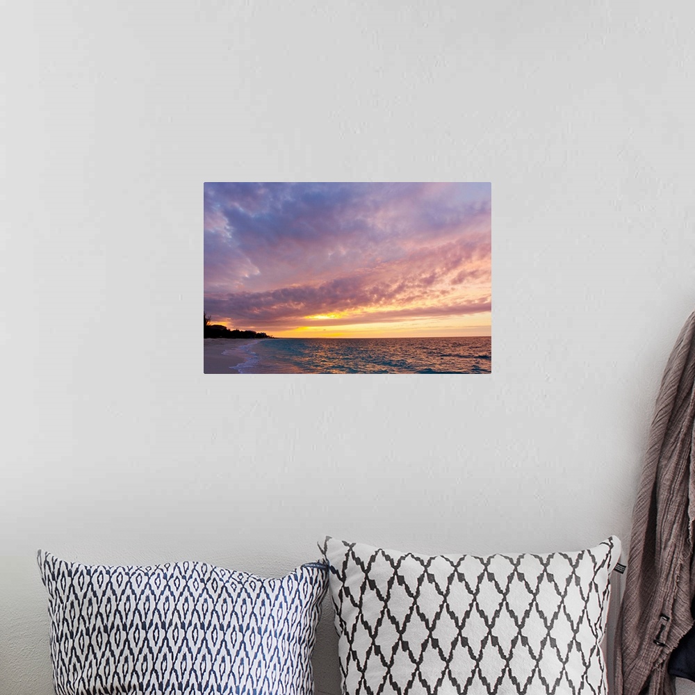 A bohemian room featuring A purple and pink sky at sunset over Grace Bay and the beach.
