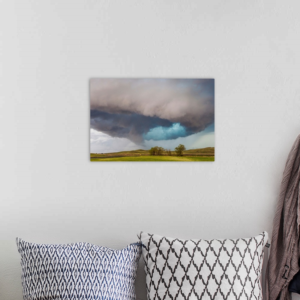 A bohemian room featuring A rotating supercell thunderstorm over hills and plains in Nebraska.