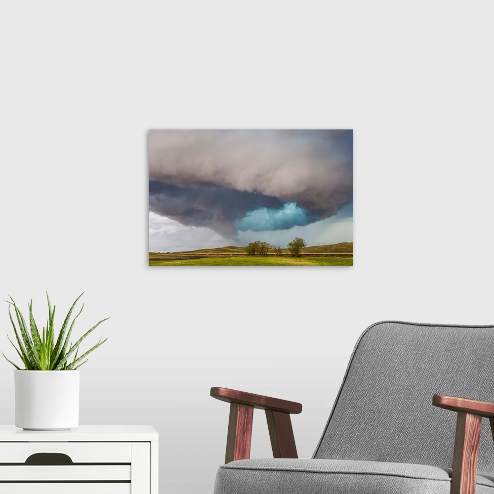 A modern room featuring A rotating supercell thunderstorm over hills and plains in Nebraska.