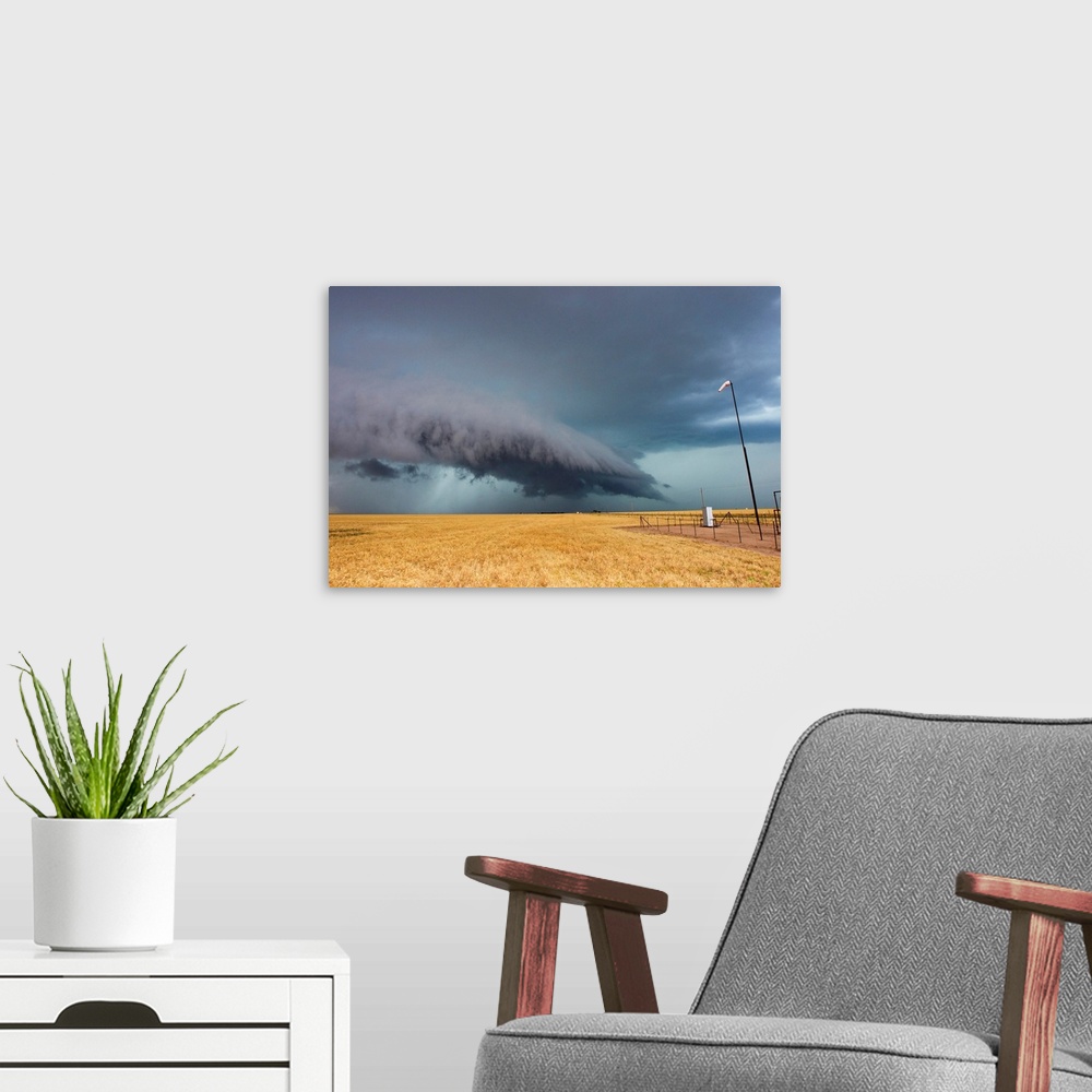 A modern room featuring A shelf cloud from a thunderstorm provides water to crops.