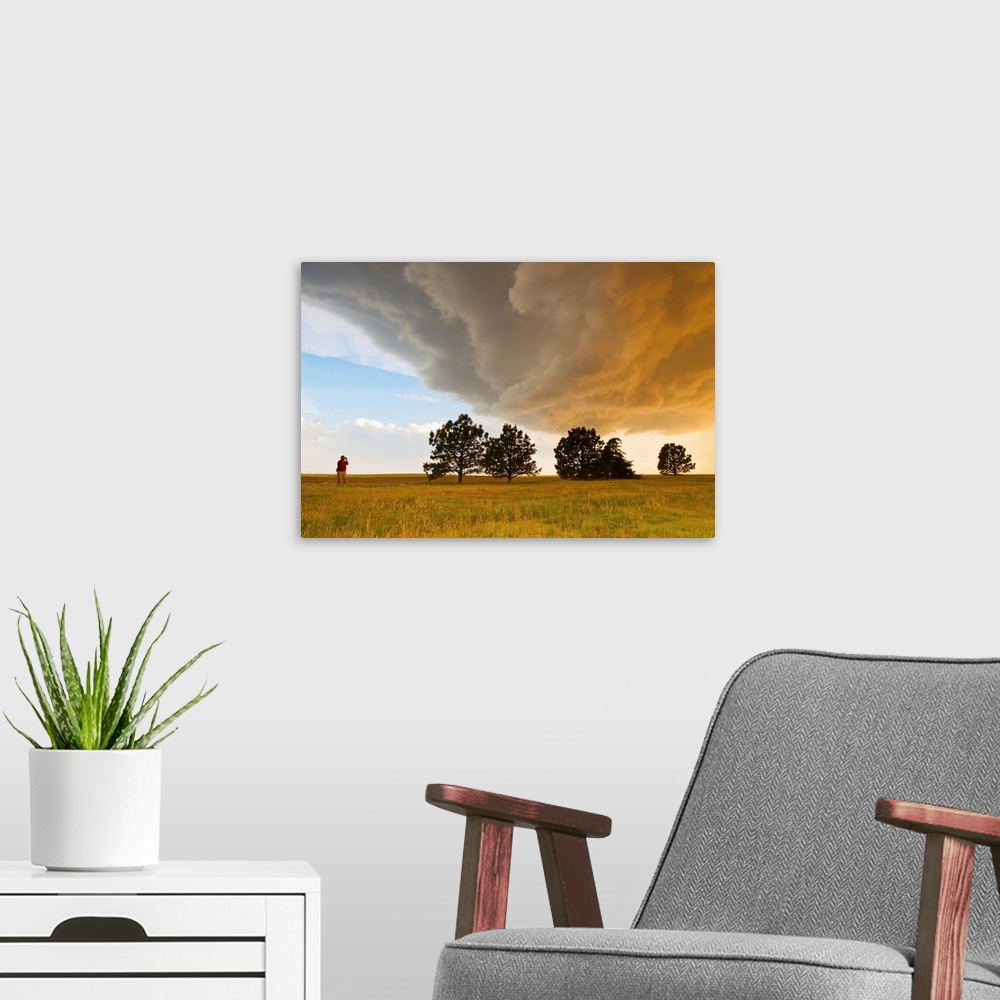 A modern room featuring A storm chaser watches a massive supercell thunderstorm in Tornado Alley.