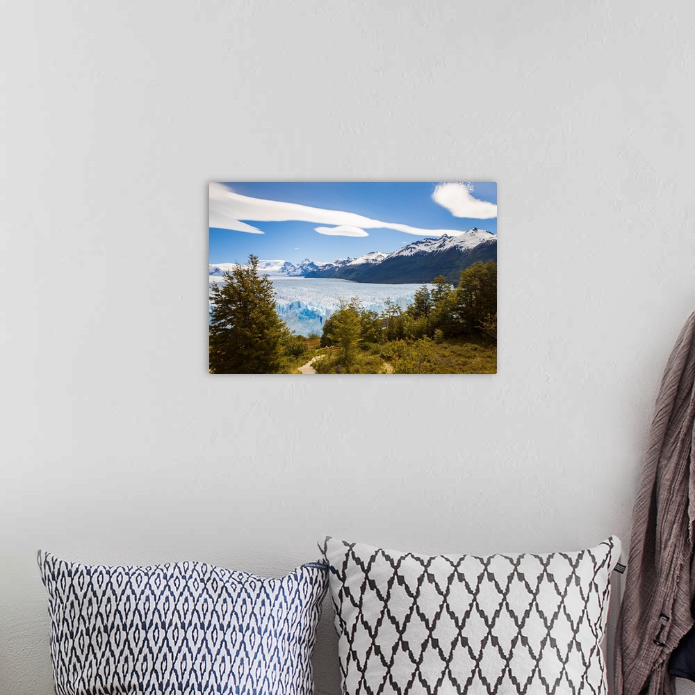 A bohemian room featuring A view looking through the trees of the top of the Perito Moreno glacier in Argentina.