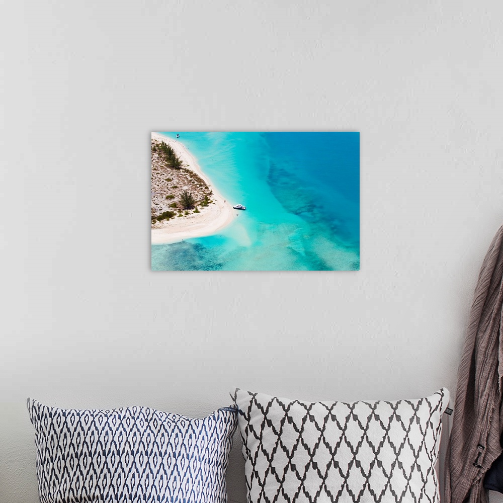 A bohemian room featuring An aerial view of boat pulled ashore on a private island in the Turks and Caicos.