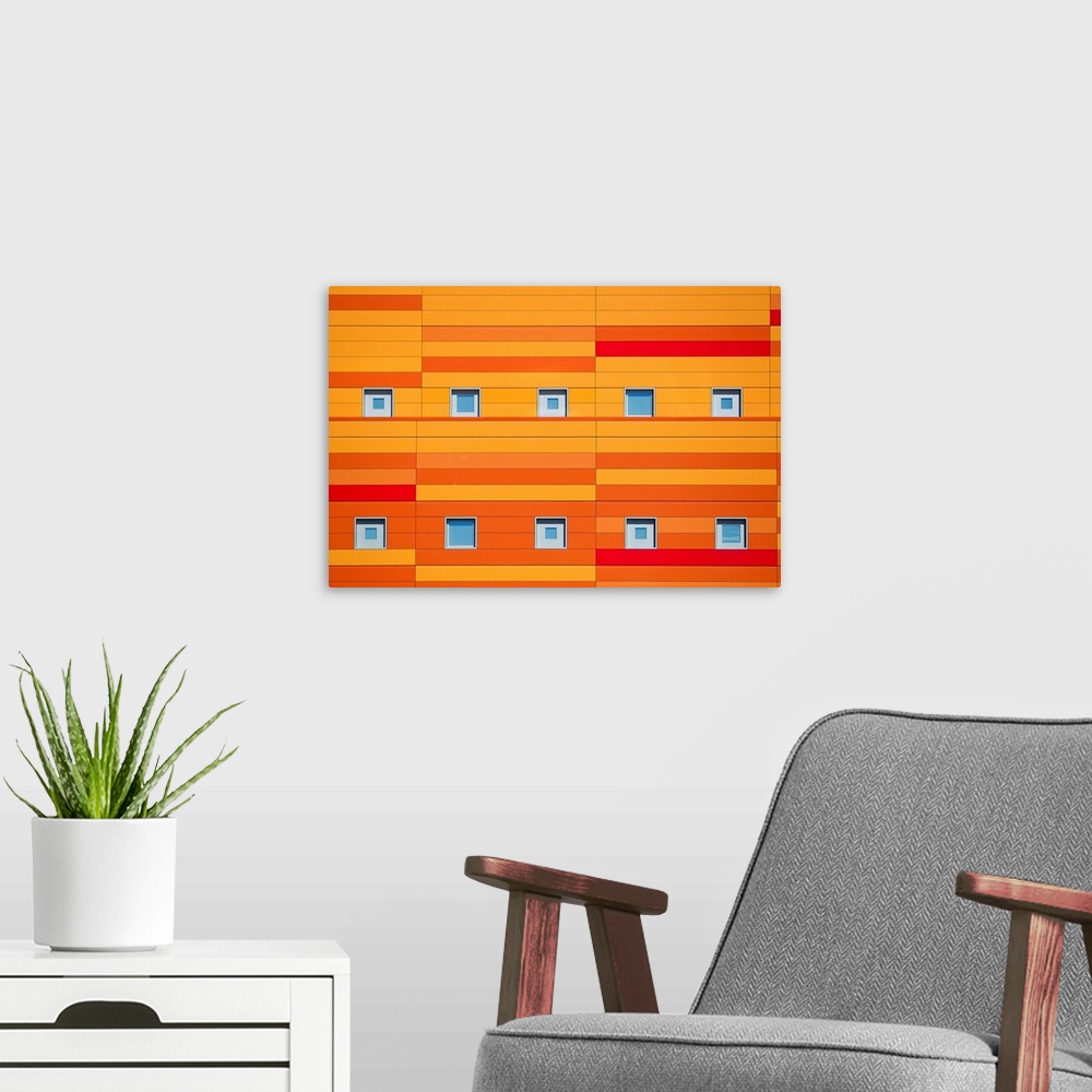 A modern room featuring An modern building decorated with bright orange stripes.