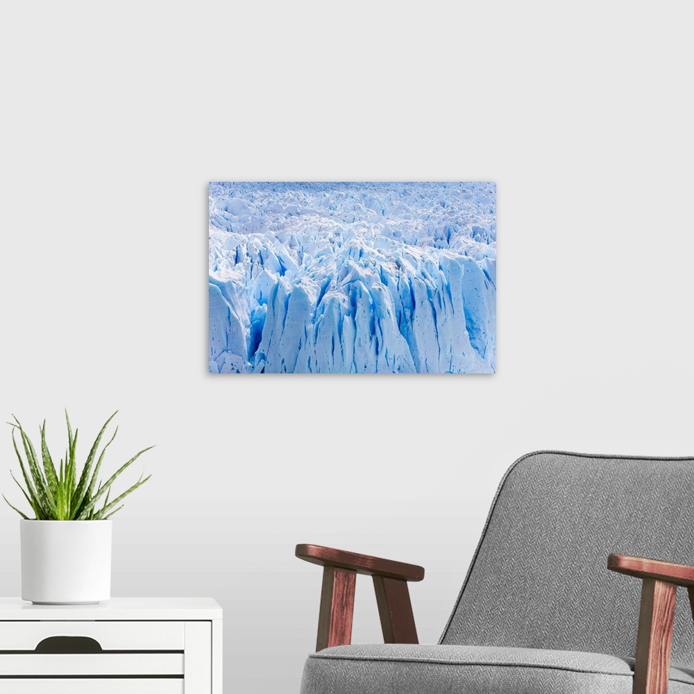 A modern room featuring Deep blue cracks on the front wall of the Perito Moreno glacier in Los Glaciares National Park.