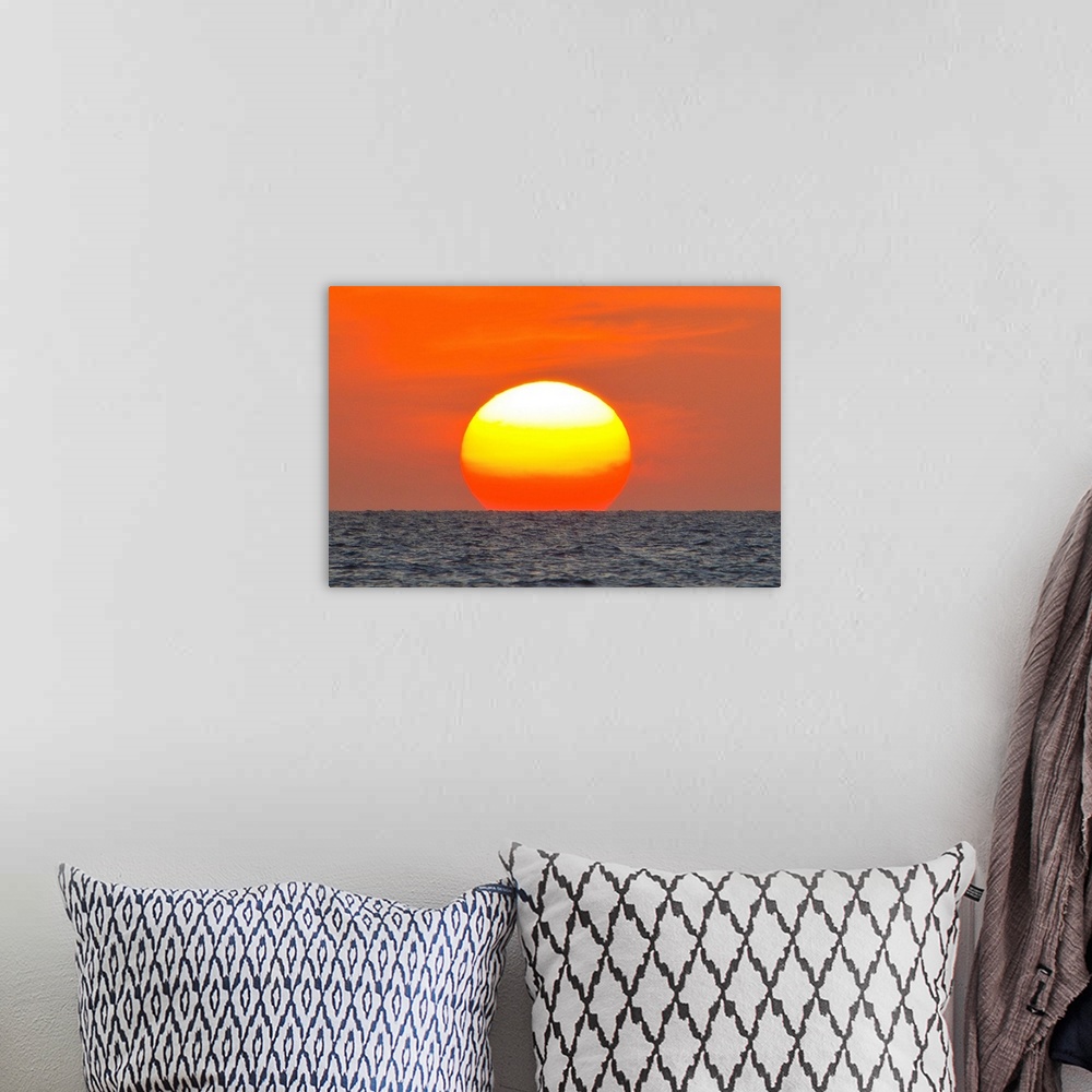 A bohemian room featuring Close up of the sun setting over the Gulf of Mexico.