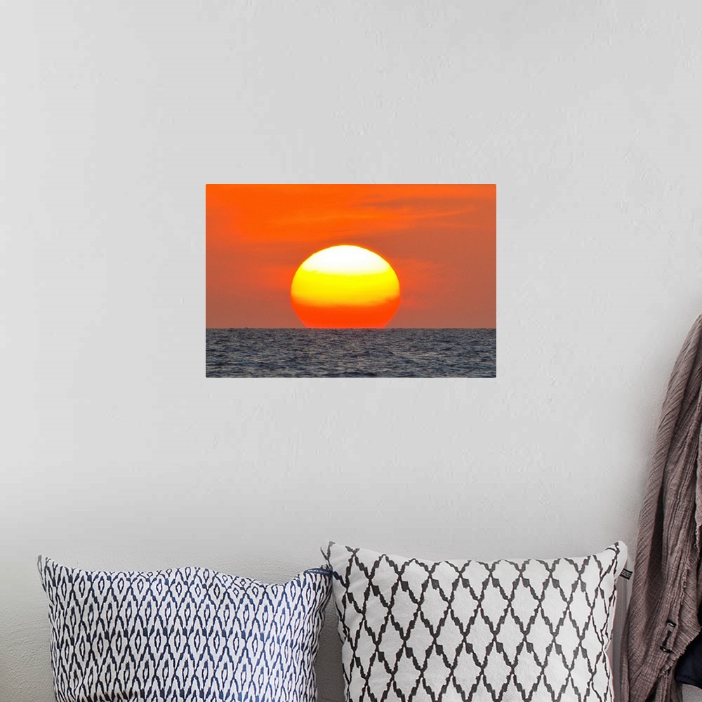 A bohemian room featuring Close up of the sun setting over the Gulf of Mexico.
