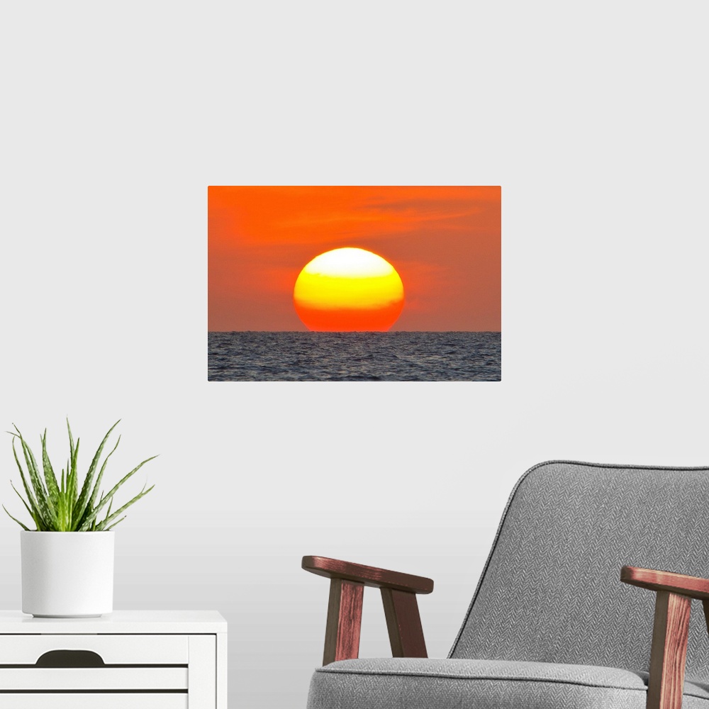 A modern room featuring Close up of the sun setting over the Gulf of Mexico.