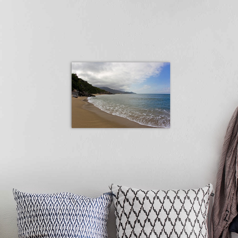 A bohemian room featuring Clouds and surf rolls in at a tropical beach.
