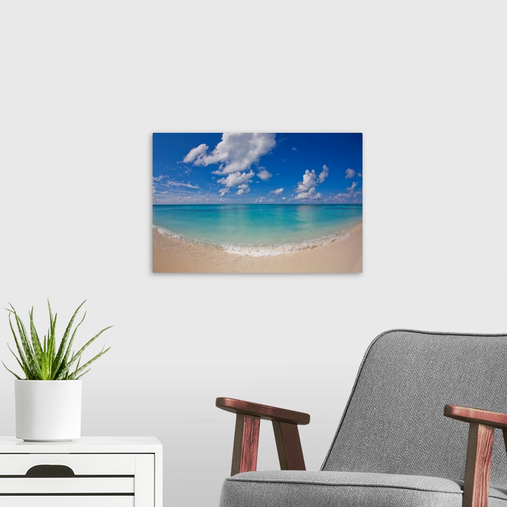 A modern room featuring Perfect beach day with blue skies, clear water, puffy white clouds.