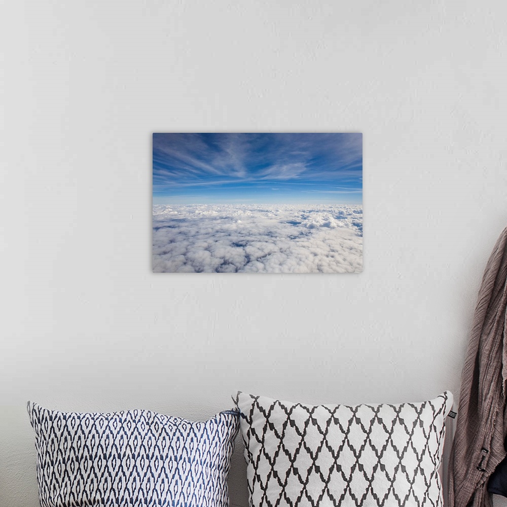 A bohemian room featuring Just above the clouds, the sky split into blue and white layers.