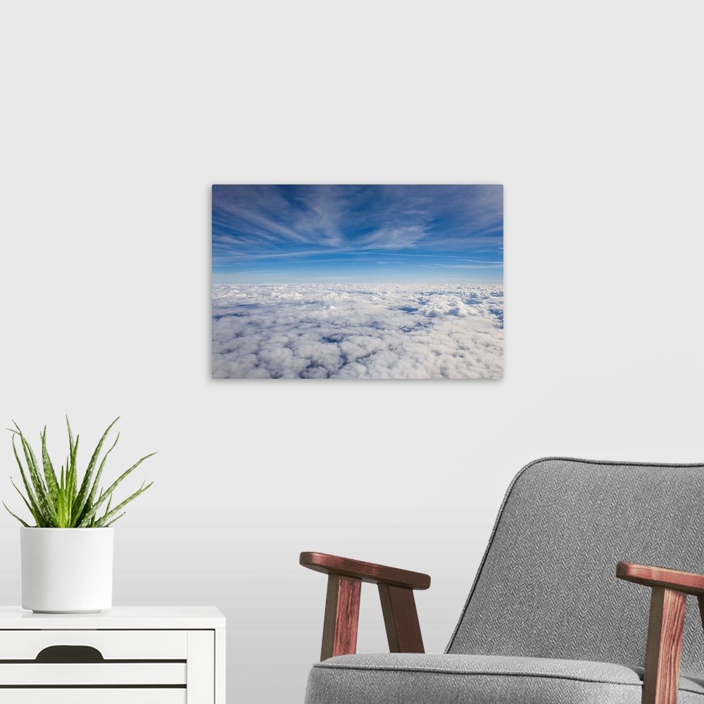 A modern room featuring Just above the clouds, the sky split into blue and white layers.