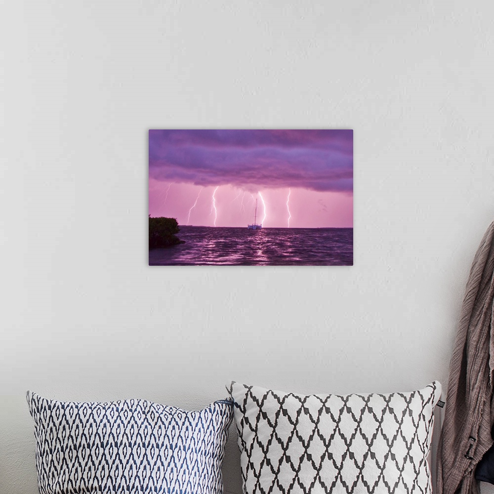 A bohemian room featuring Lightning bolts striking the ocean, and almost hitting a sailboat.