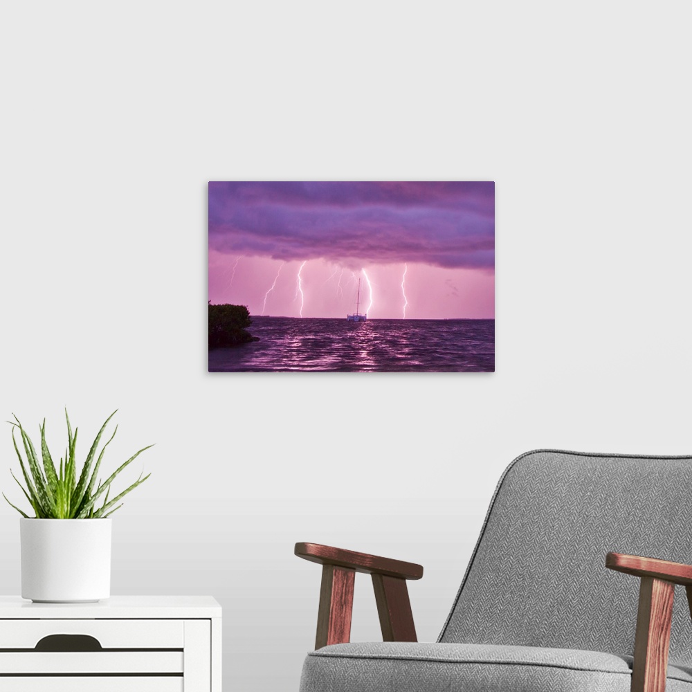 A modern room featuring Lightning bolts striking the ocean, and almost hitting a sailboat.