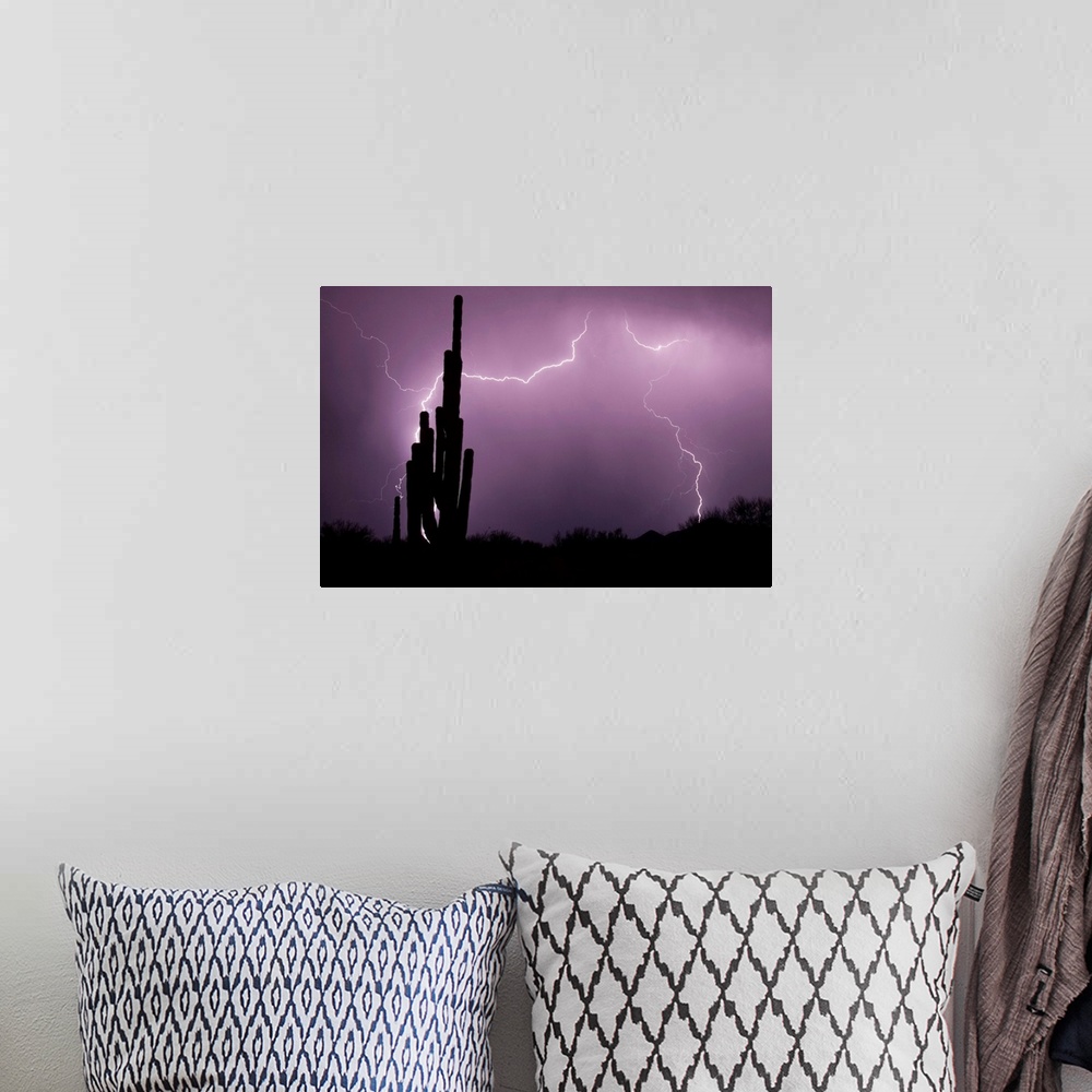A bohemian room featuring Large canvas photo art of lightning lighting up the night sky in the desert with cactus silhouett...