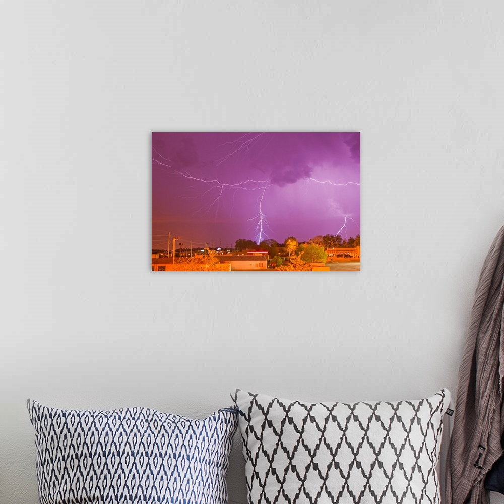 A bohemian room featuring Multiple lightning bolts during an intense lightning storm.