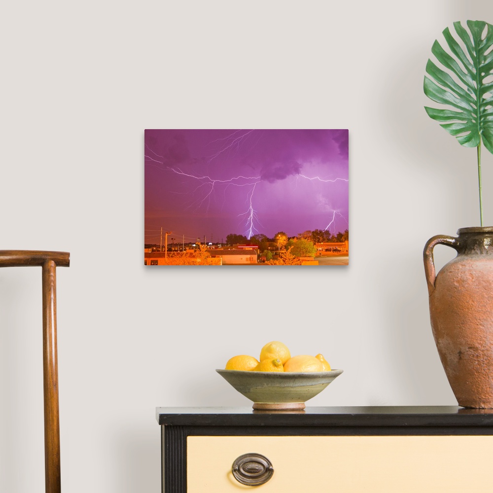 A traditional room featuring Multiple lightning bolts during an intense lightning storm.