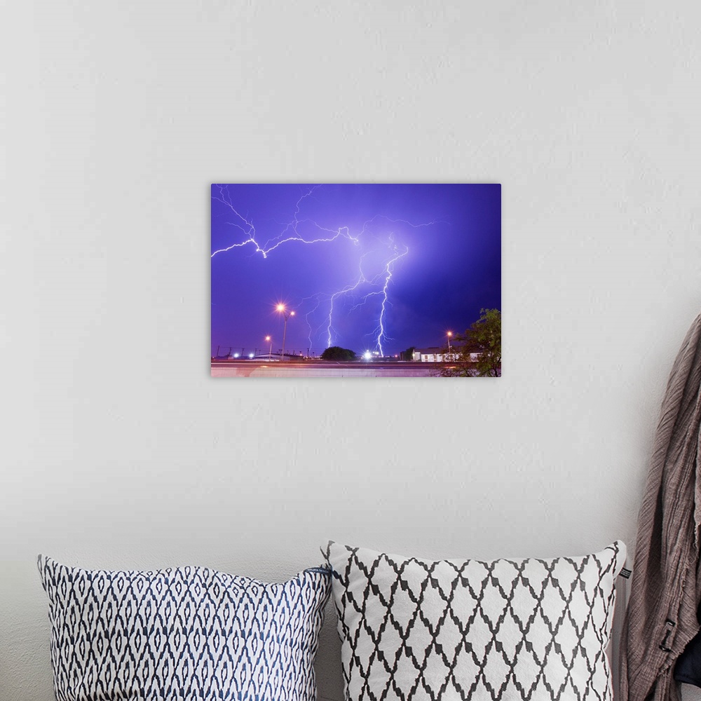 A bohemian room featuring Multiple lightning bolts stike from an intense lightning thunderstorm.