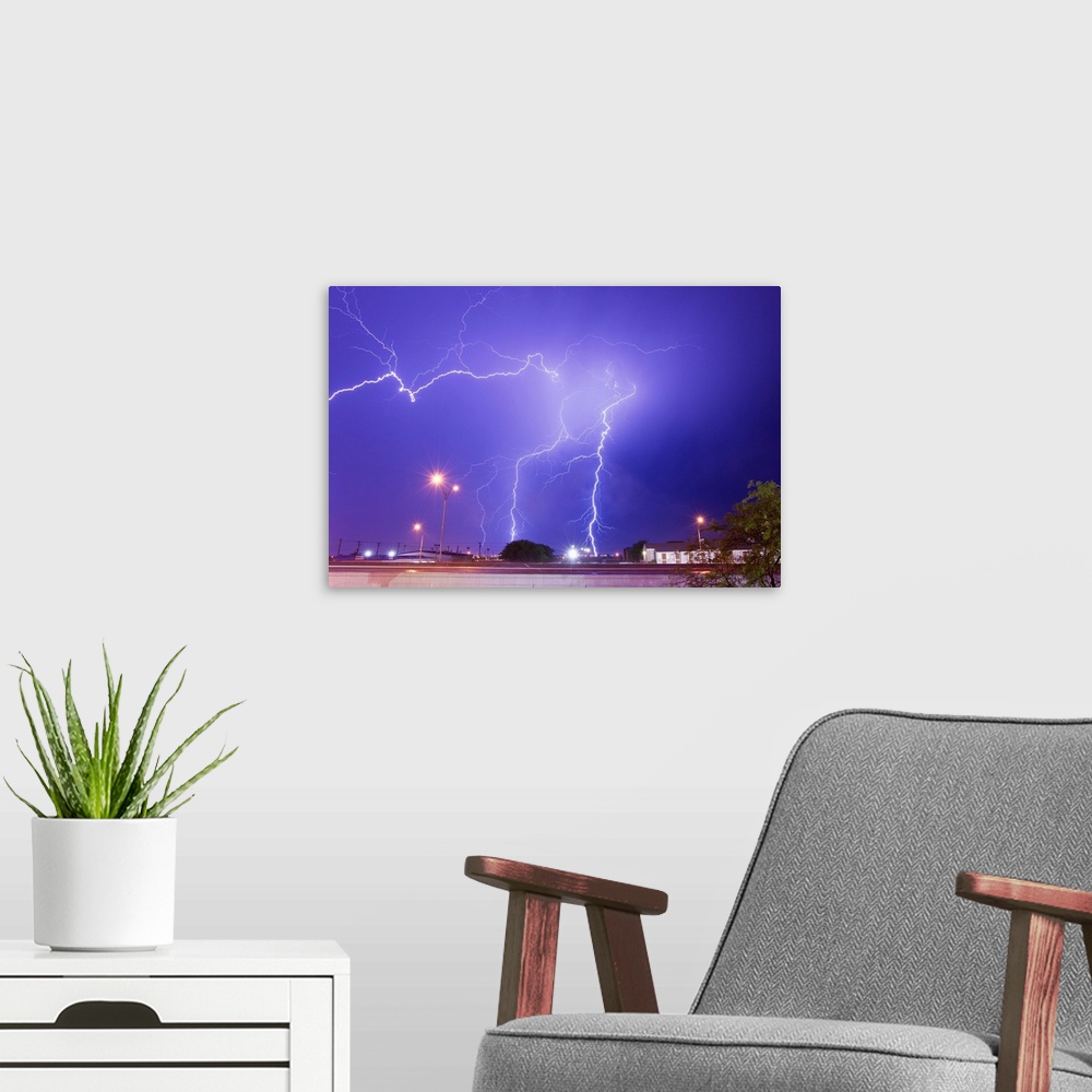 A modern room featuring Multiple lightning bolts stike from an intense lightning thunderstorm.