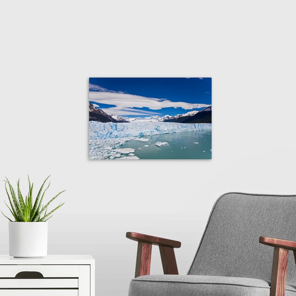 A modern room featuring Perito Moreno glacier wall and floating ice that broke off the wall.