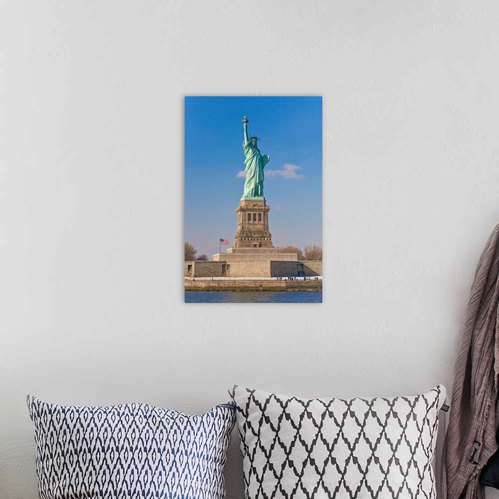 A bohemian room featuring Tourists at the Statue of Liberty National Monument.