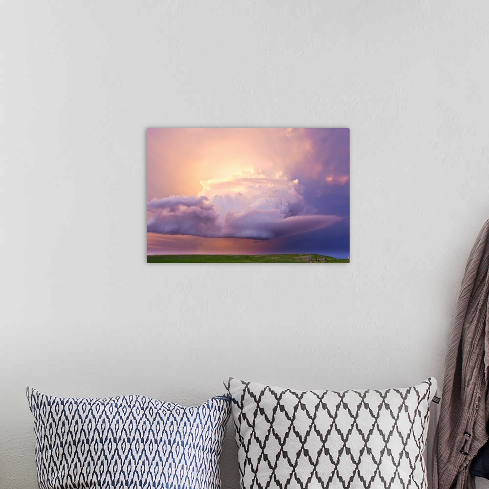 A bohemian room featuring Sunset paints a decaying thunderstorm and the sky a glowing purple and pink.