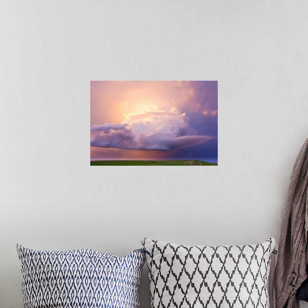A bohemian room featuring Sunset paints a decaying thunderstorm and the sky a glowing purple and pink.