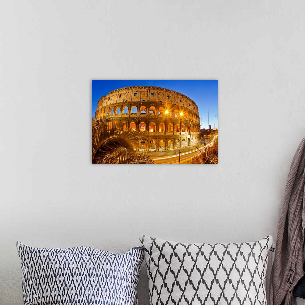 A bohemian room featuring The ancient Roman Colosseum casts an illuminated golden light at dusk.