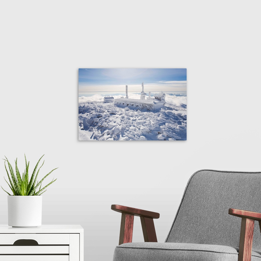 A modern room featuring The Mount Washington observatory, completely covered in rime ice.