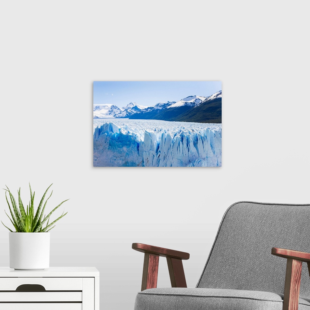 A modern room featuring Deep blue cracks line the front wall of the Perito Moreno glacier in Los Glaciares National Park.