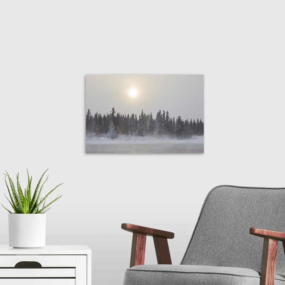 A modern room featuring The sun glowing through thick clouds in subzero temperatures along the Yukon River.