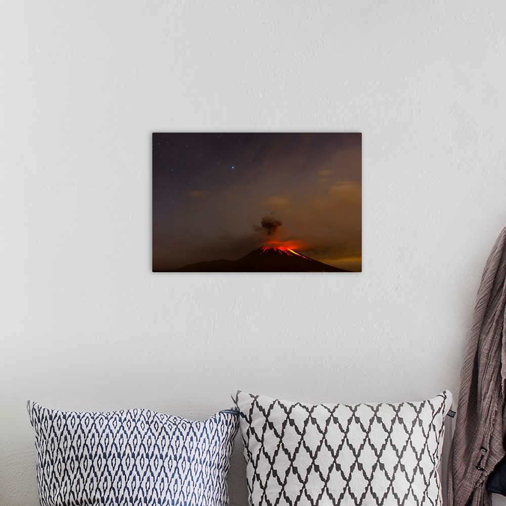 A bohemian room featuring The Tungurahua volcano erupting at night under a starry sky.
