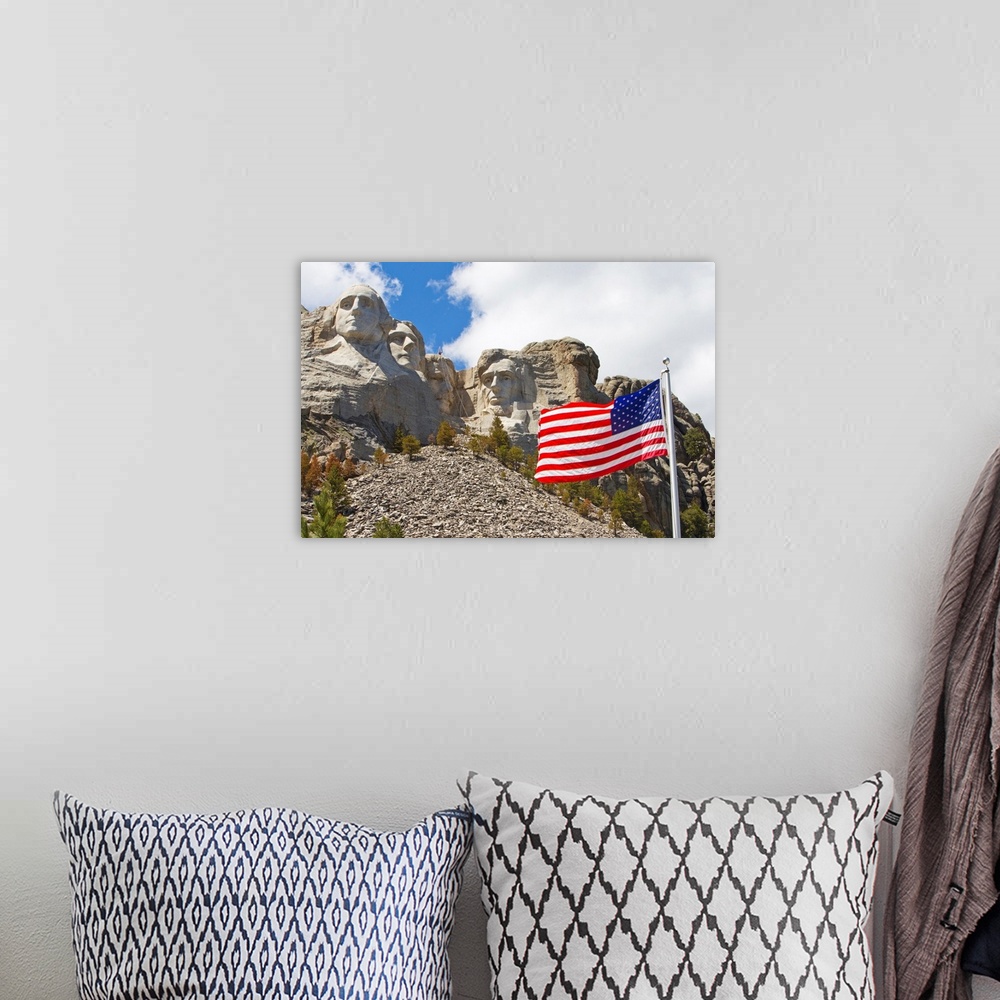 A bohemian room featuring The United States flag proudly flying in front of Mount Rushmore.