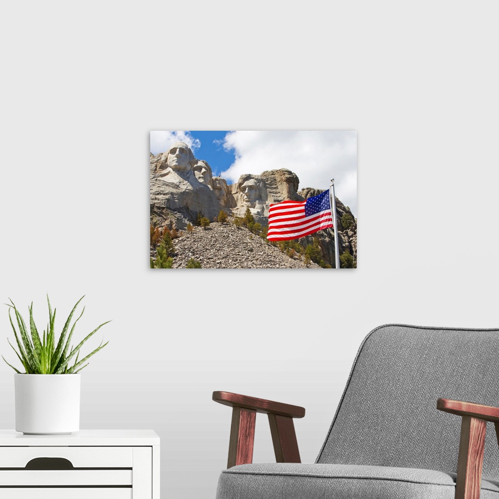 A modern room featuring The United States flag proudly flying in front of Mount Rushmore.